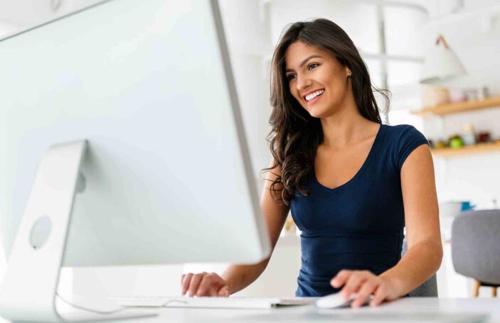 Beautiful student woman learning online on computer at home. Technology, education concept